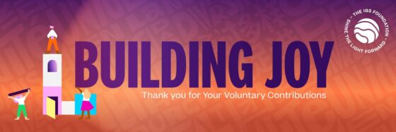 Three illustrated people build a purple and white tower against a colourful orange and purple background, with large text reading Building Joy and a thank you for voluntary contributions. The IGS Foundation logo is in the top right corner.